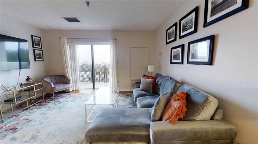 300 Johnson Ferry Road, Unit B605 Atlanta, GA 30328 - Photo 15 of 33 a living room with furniture and a flat screen tv