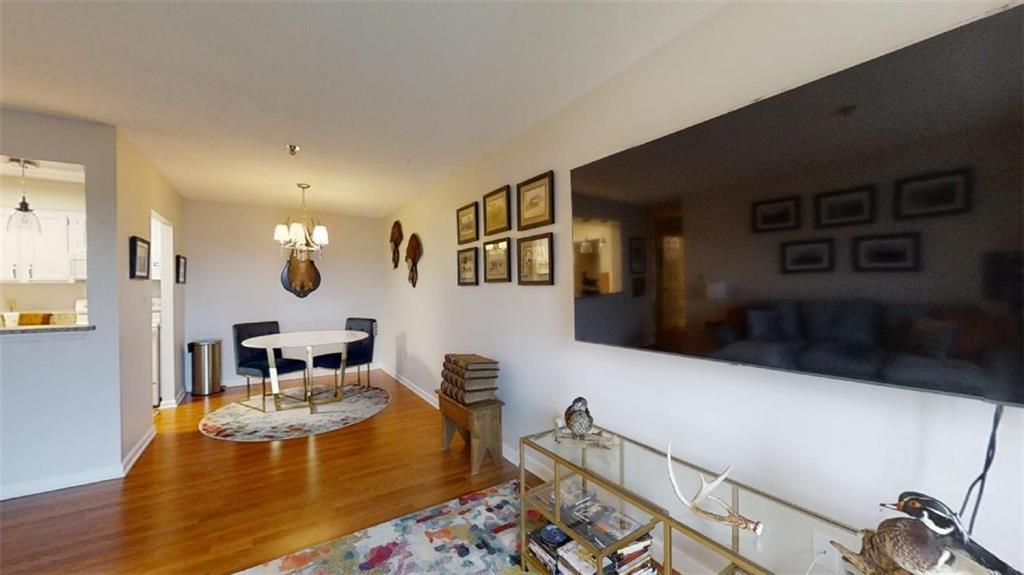 300 Johnson Ferry Road, Unit B605 Atlanta, GA 30328 - Photo 18 of 33 a living room with furniture wooden floor and a table
