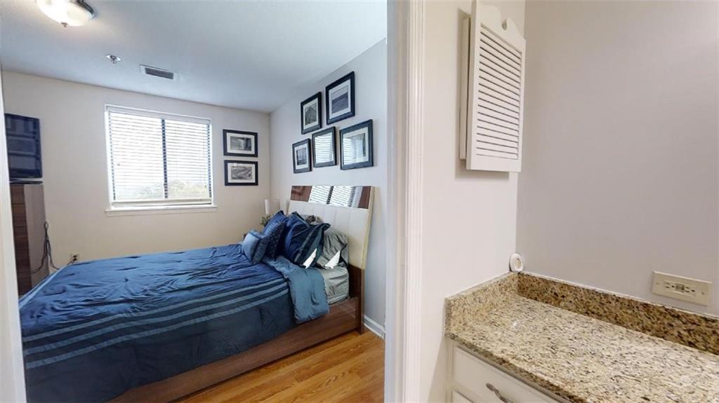 300 Johnson Ferry Road, Unit B605 Atlanta, GA 30328 - Photo 22 of 33 a bedroom with a bed and a window with kitchen view