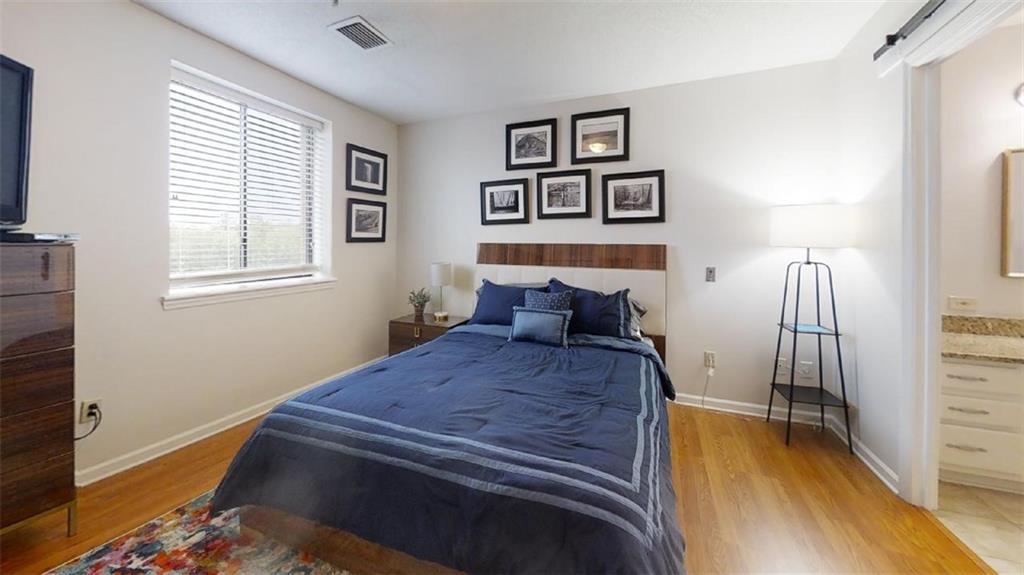 300 Johnson Ferry Road, Unit B605 Atlanta, GA 30328 - Photo 23 of 33 a bed room with a bed and a tv