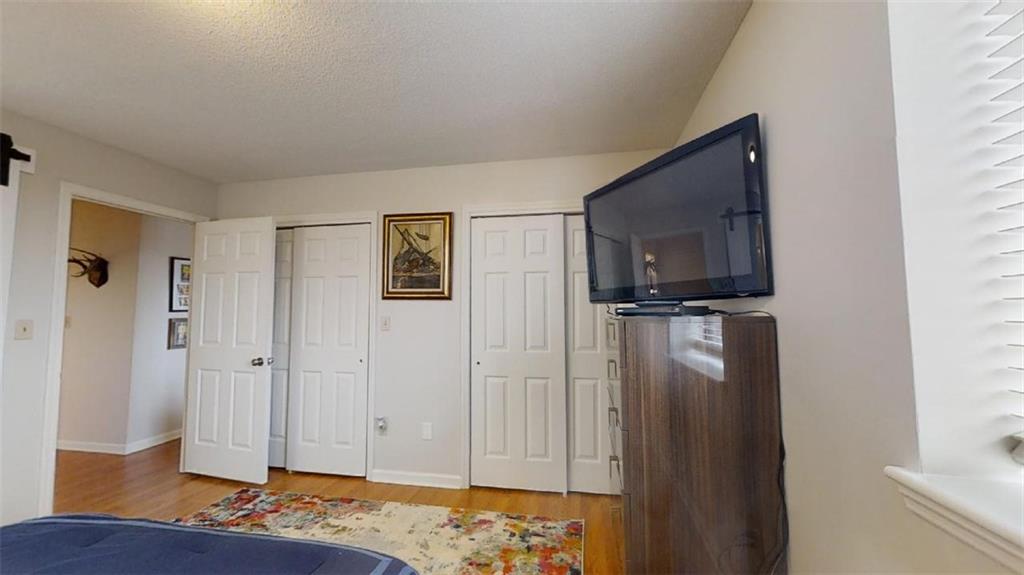 300 Johnson Ferry Road, Unit B605 Atlanta, GA 30328 - Photo 26 of 33 a view of a bedroom with wooden floor cabinets and staircase