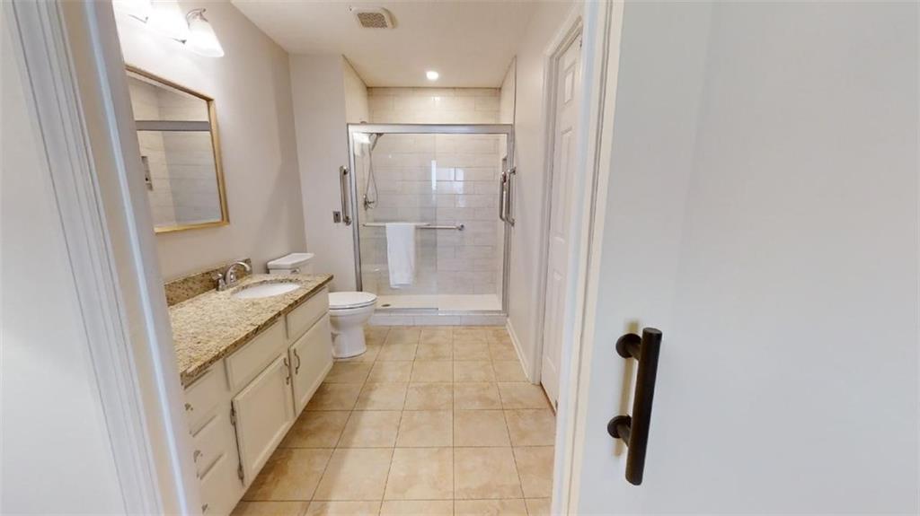 300 Johnson Ferry Road, Unit B605 Atlanta, GA 30328 - Photo 28 of 33 a bathroom with a granite countertop sink a mirror and a bathtub