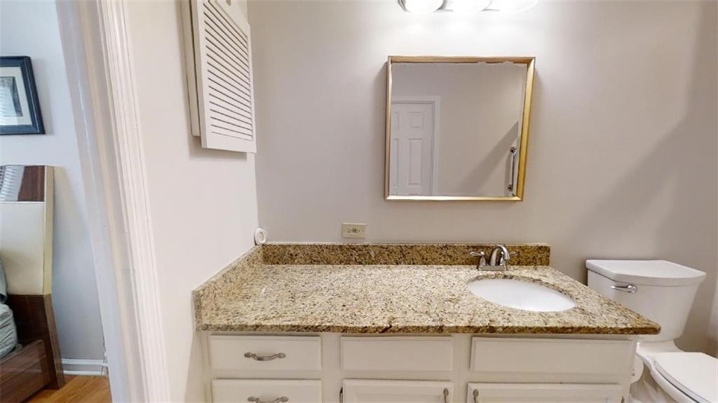 300 Johnson Ferry Road, Unit B605 Atlanta, GA 30328 - Photo 29 of 33 a bathroom with a granite countertop sink and a mirror