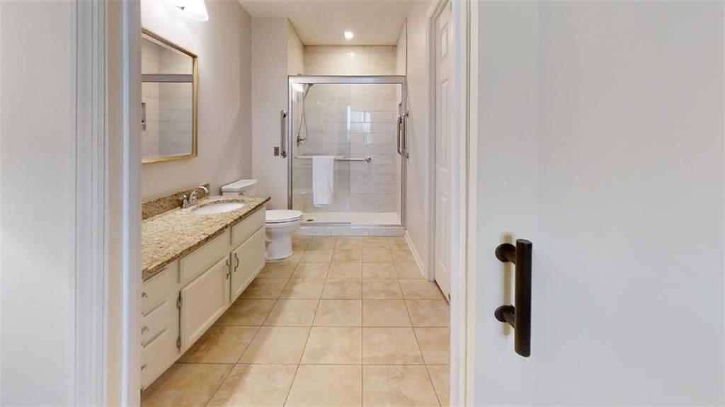 300 Johnson Ferry Road, Unit B605 Atlanta, GA 30328 - Photo 30 of 33 a bathroom with a granite countertop sink a mirror and a shower