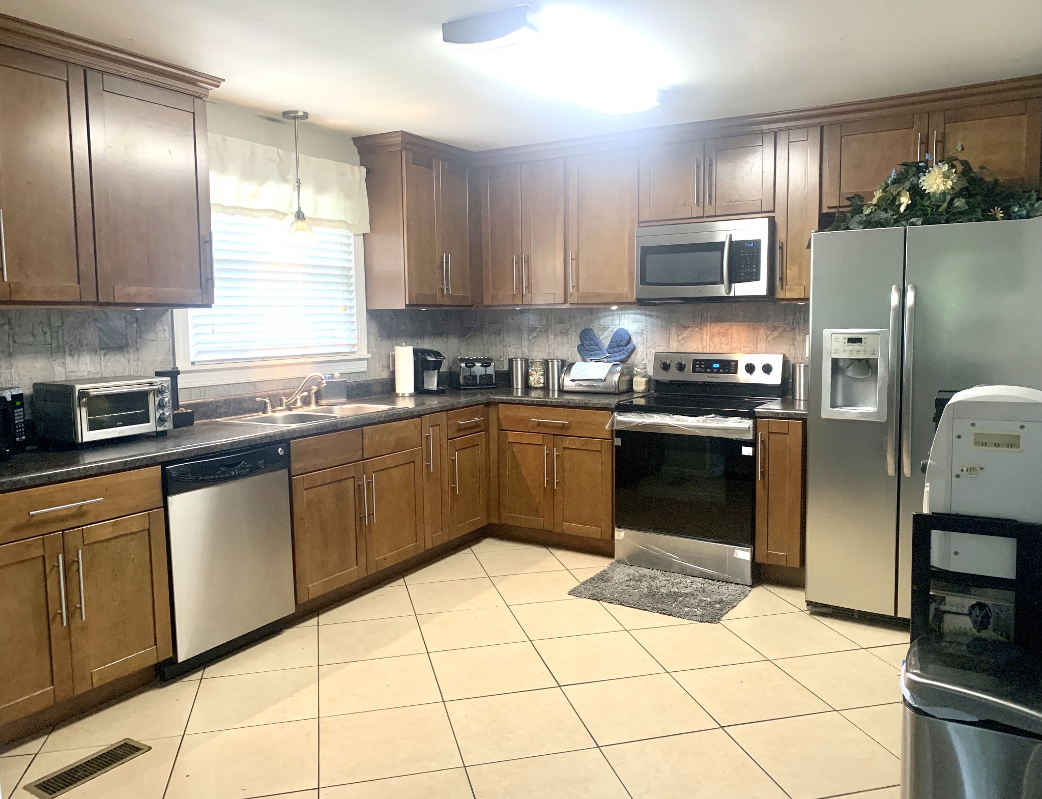 562 Walton Ferry Road Hendersonville, TN 37075 - Photo 9 of 24 a kitchen with stainless steel appliances granite countertop a stove a sink a microwave a refrigerator and cabinets