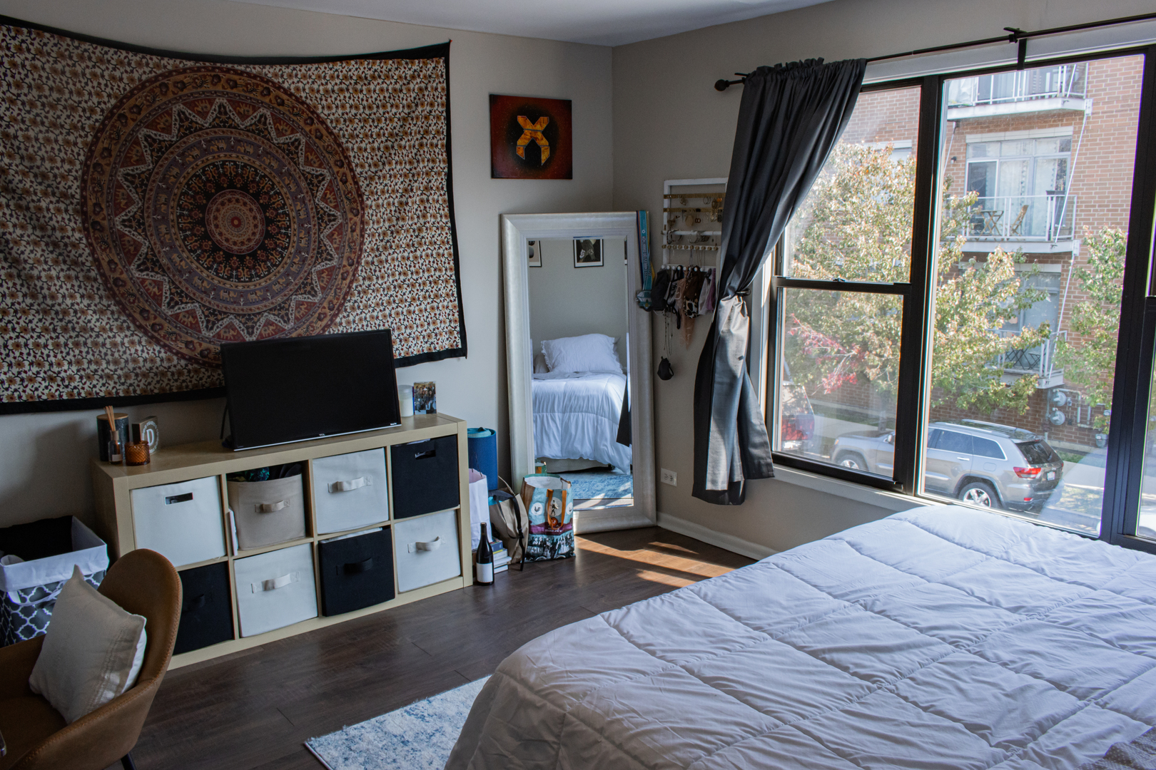 440 North Racine Avenue, Unit 2 Chicago, IL 60642 - Photo 13 of 20 a bedroom with furniture and a fireplace
