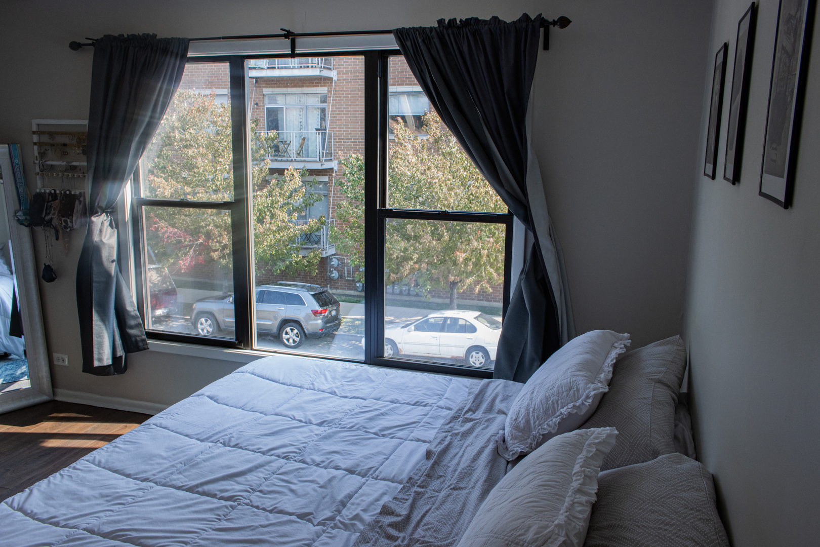 440 North Racine Avenue, Unit 2 Chicago, IL 60642 - Photo 14 of 20 a bedroom with a bed and wooden floor