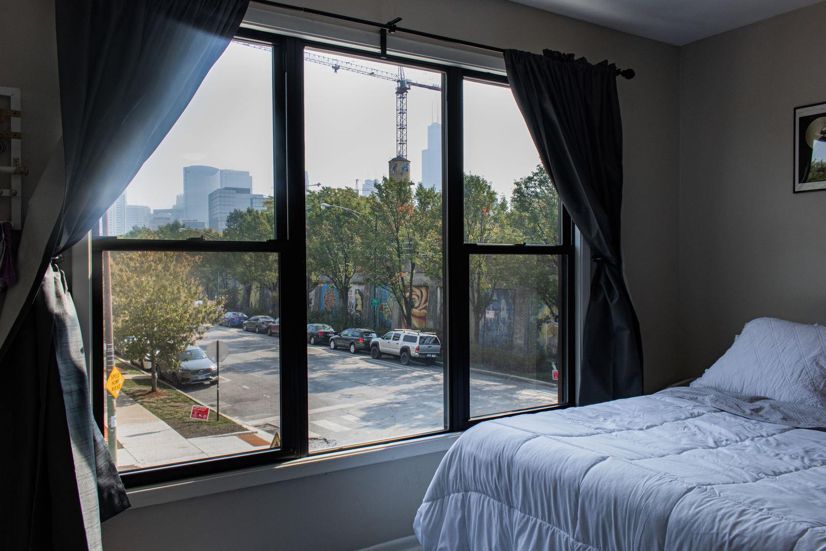 440 North Racine Avenue, Unit 2 Chicago, IL 60642 - Photo 16 of 20 a bedroom with a bed and a large window