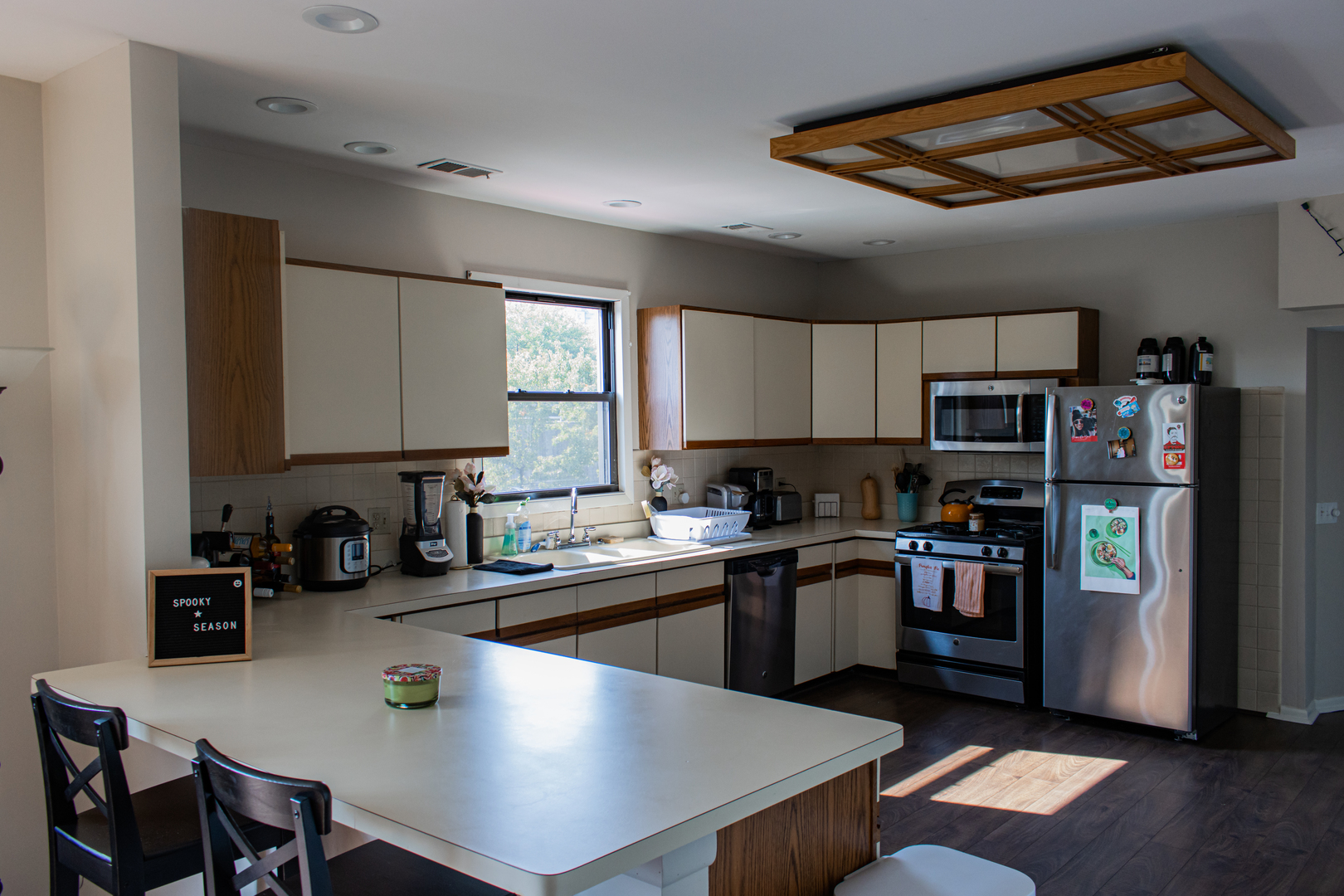 440 North Racine Avenue, Unit 2 Chicago, IL 60642 - Photo 4 of 20 a kitchen with stainless steel appliances granite countertop a sink dishwasher stove refrigerator and microwave with wooden floor
