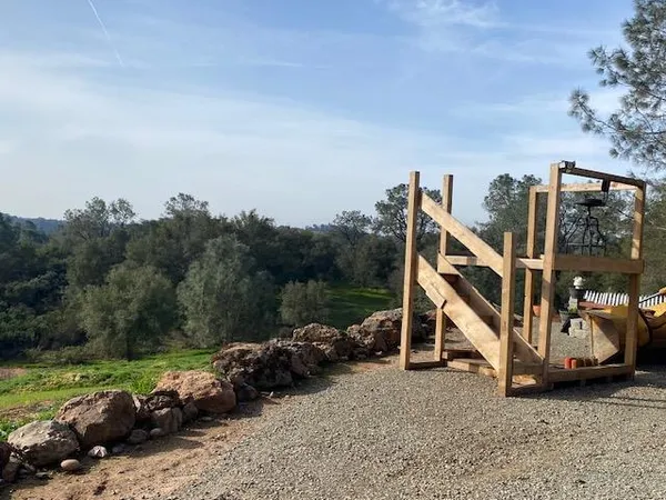 a view of a house with a yard and sitting area