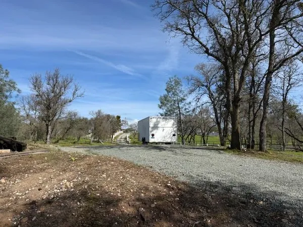 a view of outdoor space with lots of swings and slides