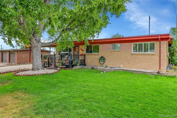 a front view of house with yard and outdoor seating