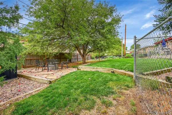 a view of a backyard with sitting area
