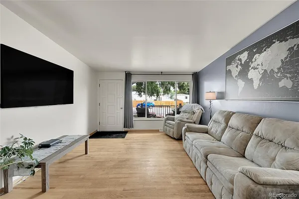 a living room with furniture and a flat screen tv
