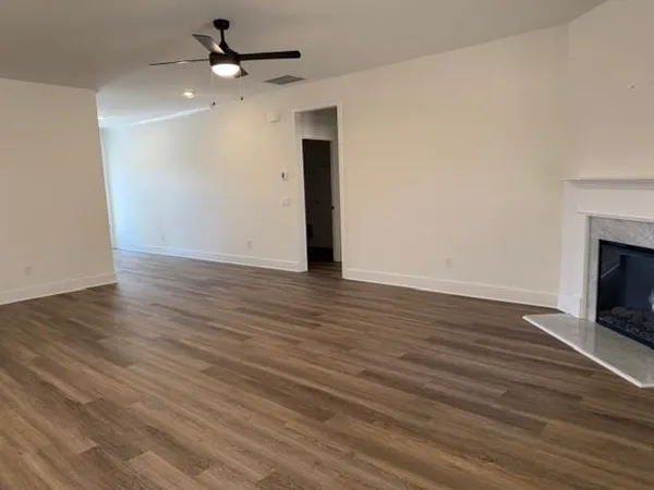 wooden floor in an empty room with a fireplace