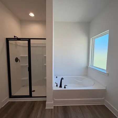 a bathroom with a bathtub and a shower