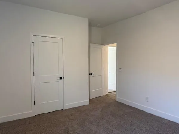 an empty room with closet area