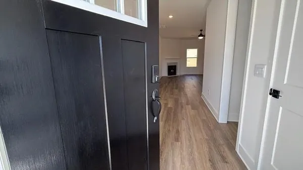 a view of hallway with wooden floor