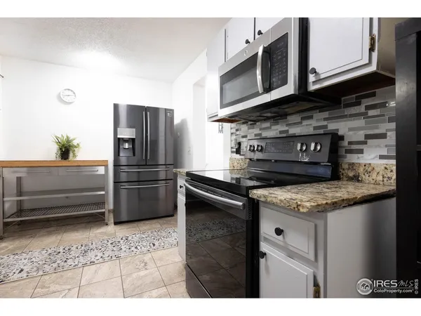 a kitchen with a sink cabinets and window