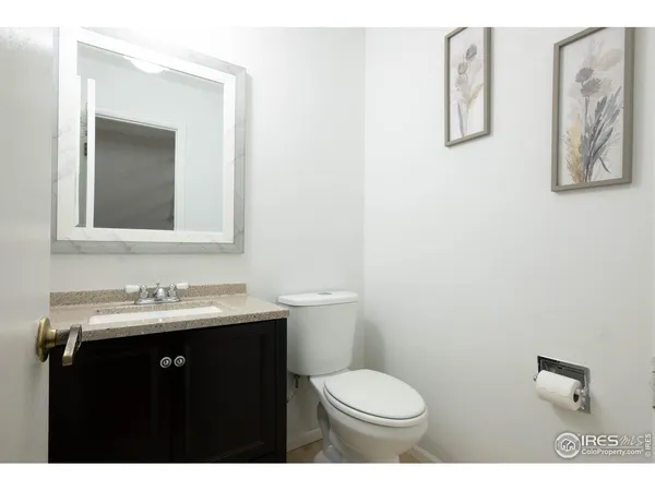 an empty room with wooden floor closet and windows