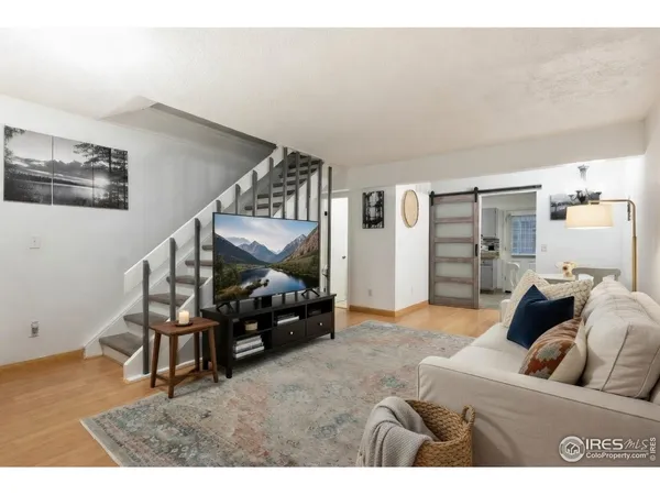 a living room with furniture and stairs