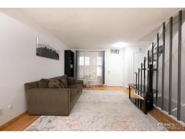 a room with a table chairs and a refrigerator