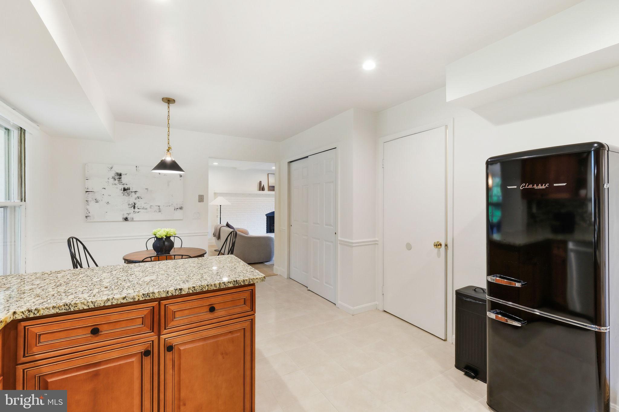 10900 Gainsborough Road Potomac, MD 20854 - Photo 13 of 44 a kitchen with granite countertop a refrigerator and a sink