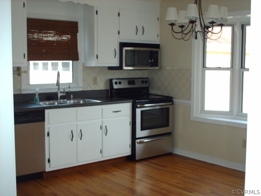 3560 Hemlock Road Chester, VA 23831 - Photo 5 of 16 a kitchen with granite countertop a stove a sink and a microwave
