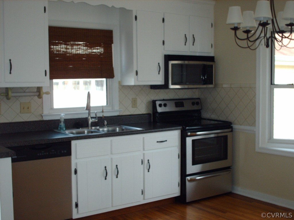 3560 Hemlock Road Chester, VA 23831 - Photo 7 of 16 a kitchen with granite countertop white cabinets appliances and a window
