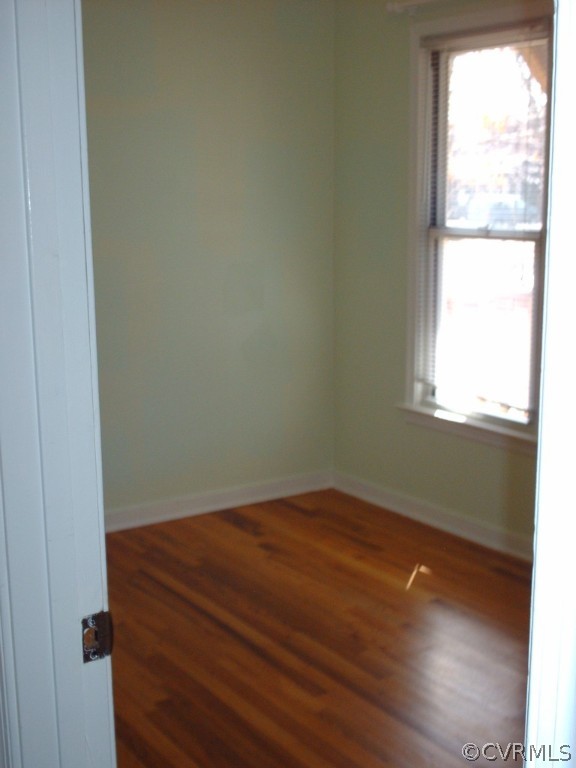 3560 Hemlock Road Chester, VA 23831 - Photo 9 of 16 an empty room with wooden floor and windows