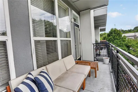 a balcony view with couches and wooden floor