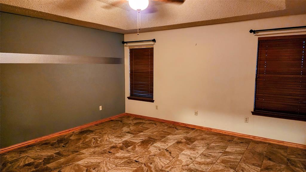 7505 Patsy Court Arlington, TX 76016 - Photo 18 of 38 Bedroom featuring dark stone finish tile floors.
