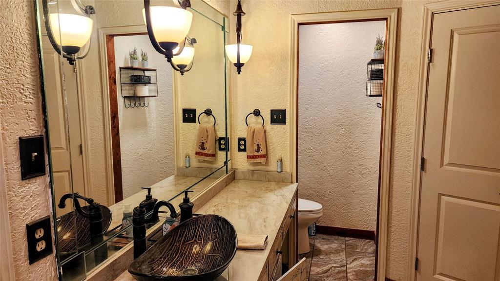7505 Patsy Court Arlington, TX 76016 - Photo 26 of 38 Bathroom with a textured wall, vanity, light tile patterned floors, and a textured ceiling.