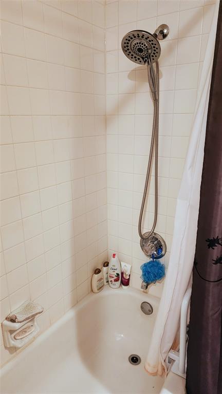7505 Patsy Court Arlington, TX 76016 - Photo 27 of 38 Bathroom view of shower / bath combo with shower curtain.