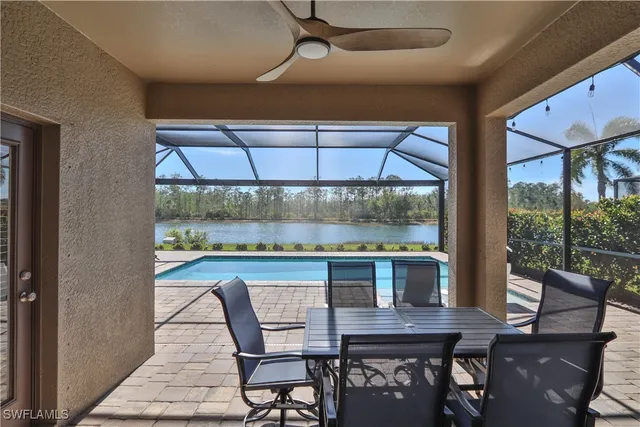 a dining room with furniture a rug and a floor to ceiling window