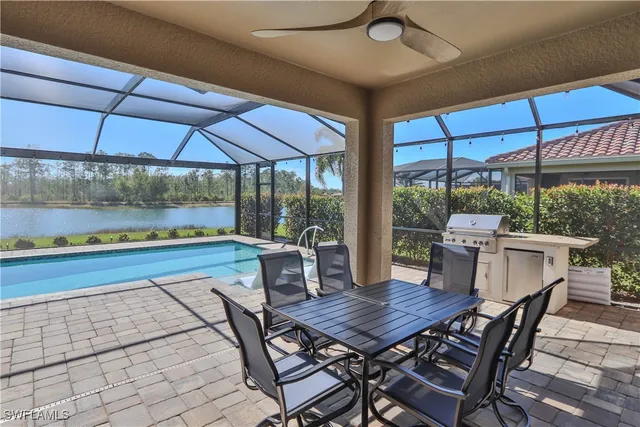 a view of a patio with a table and chairs under an umbrella