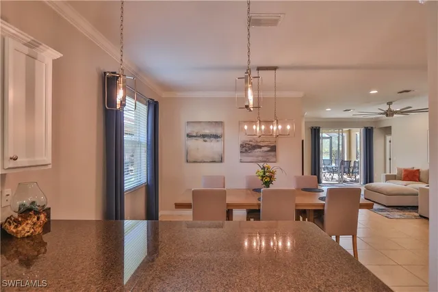 a living room with furniture a chandelier and a dining table