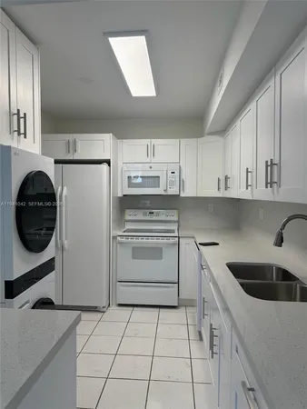 a kitchen with a sink cabinets and stainless steel appliances