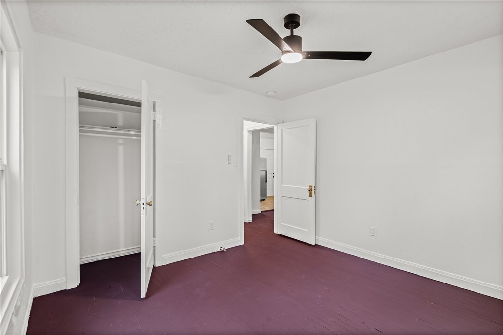 2206 Rountree Drive Austin, TX 78722 - Photo 11 of 16 Unfurnished bedroom featuring a ceiling fan and a closet