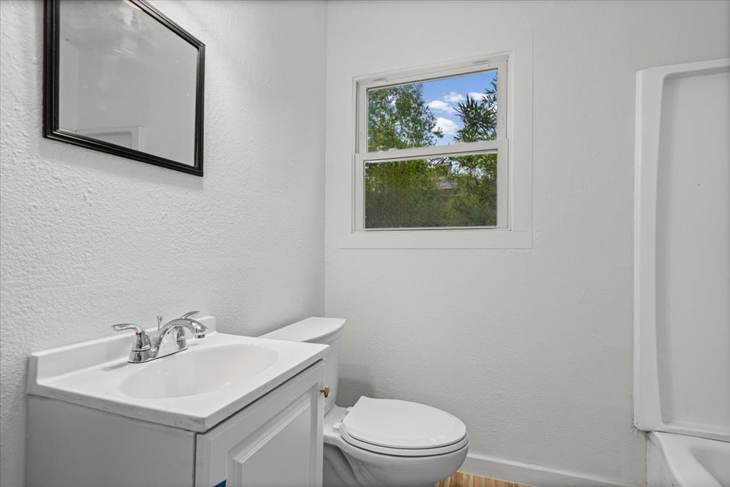 2206 Rountree Drive Austin, TX 78722 - Photo 12 of 16 Bathroom featuring a textured wall and vanity