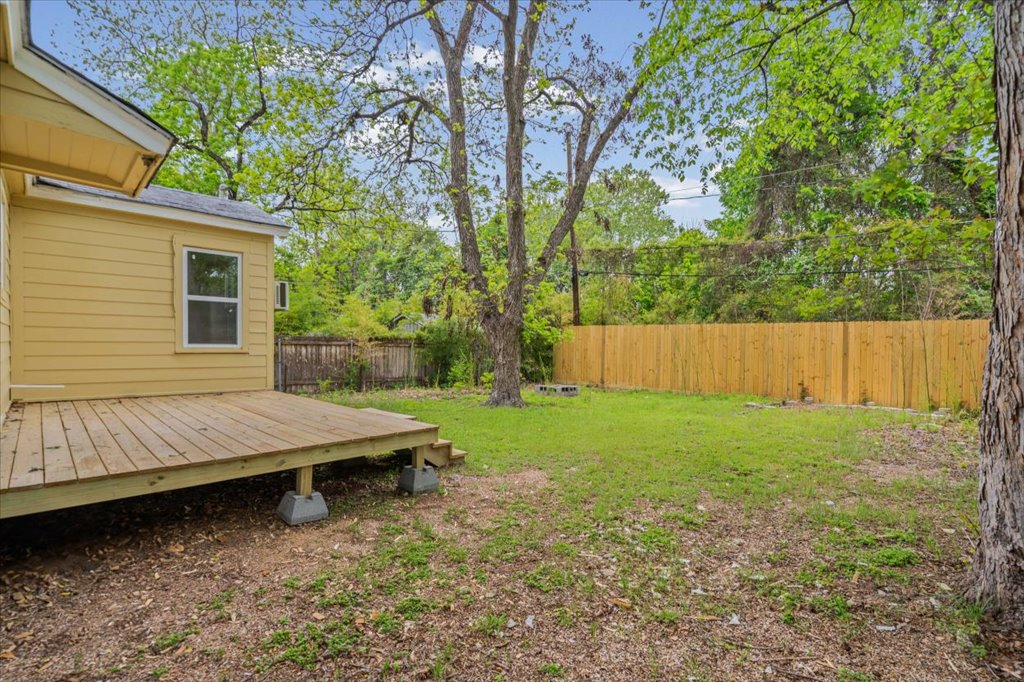 2206 Rountree Drive Austin, TX 78722 - Photo 14 of 16 Fenced backyard with a wooden deck