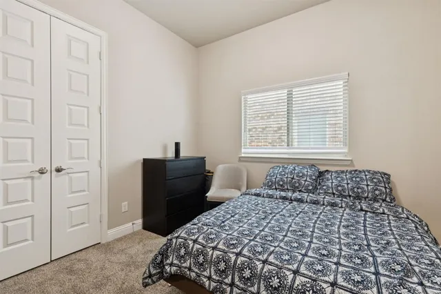 a bedroom with furniture and wooden floor