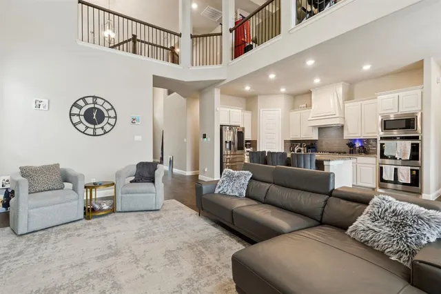 a living room with furniture and a view of kitchen