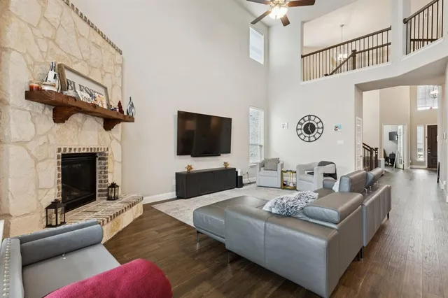 a living room with furniture a fireplace and a flat screen tv
