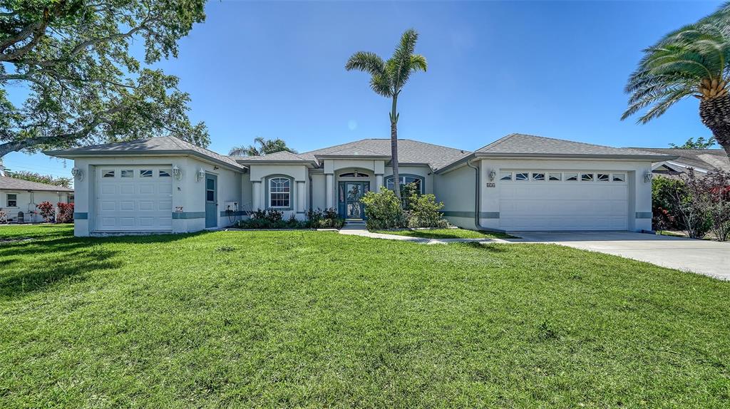 626 Magellan Drive Sarasota, FL 34243 - Photo 1 of 1 a front view of house with yard and trees