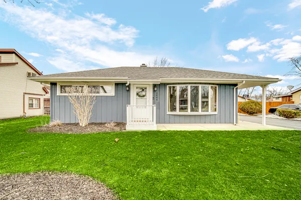 a front view of a house with a yard and pathway