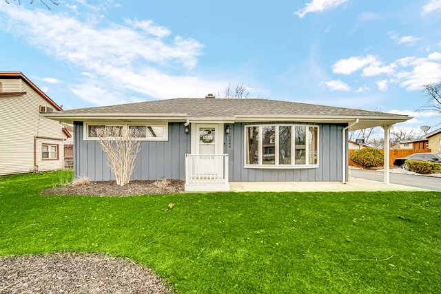 a front view of a house with a yard and pathway