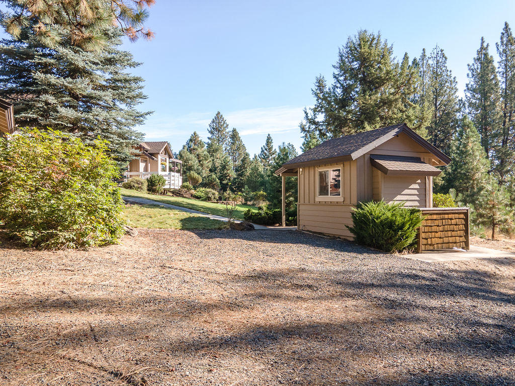 19132 Pumice Butte Road Bend, OR 97702 - Photo 35 of 49 a view of a house with a small yard and large trees