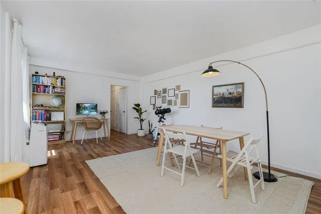 a dining room with furniture and wooden floor