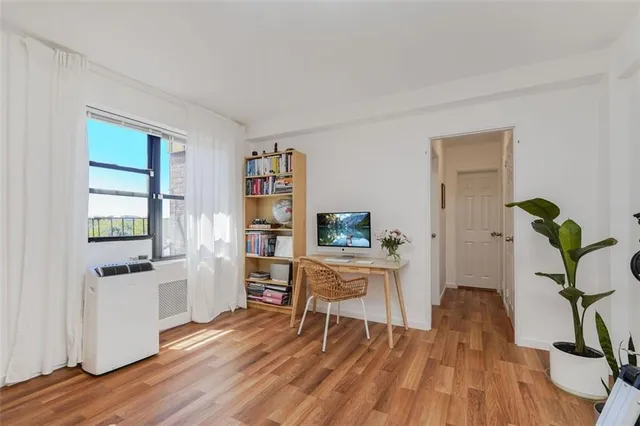 a work room with furniture and a potted plant
